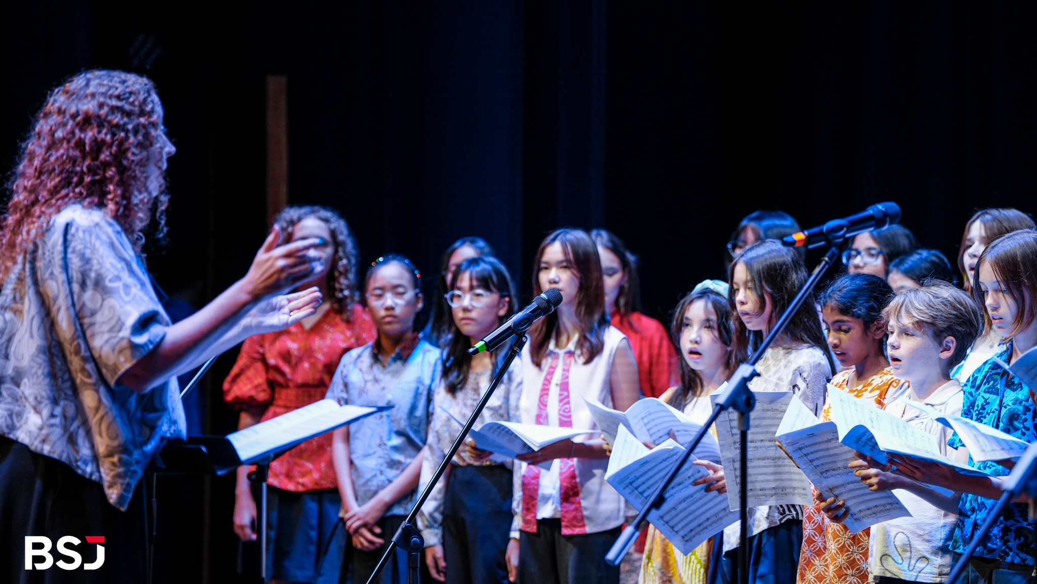 BSJ students showcasing visual art pieces during the event